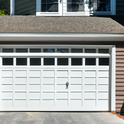 Residential garage door on a New England house in Hanover, MA, front view with driveway and minimal landscaping.